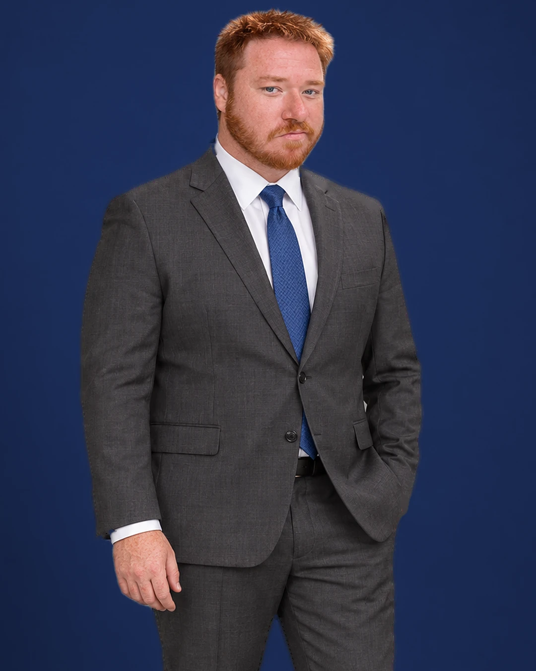 Robert Lingoes in a charcoal suit, white shirt and blue tie, against a navy background.
